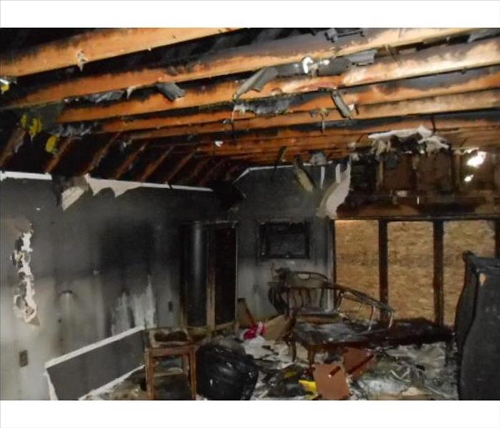burned out, debris-filled room boarded up windows