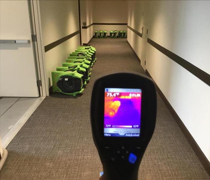 infrared camera showing a display of hot and cold in a commercial corridor with rows of air movers